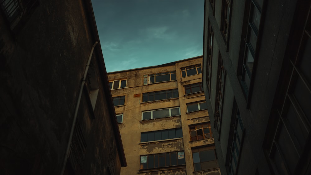 a tall building with lots of windows next to another building