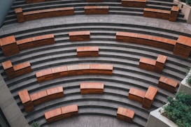 a group of wooden benches sitting on the side of a building