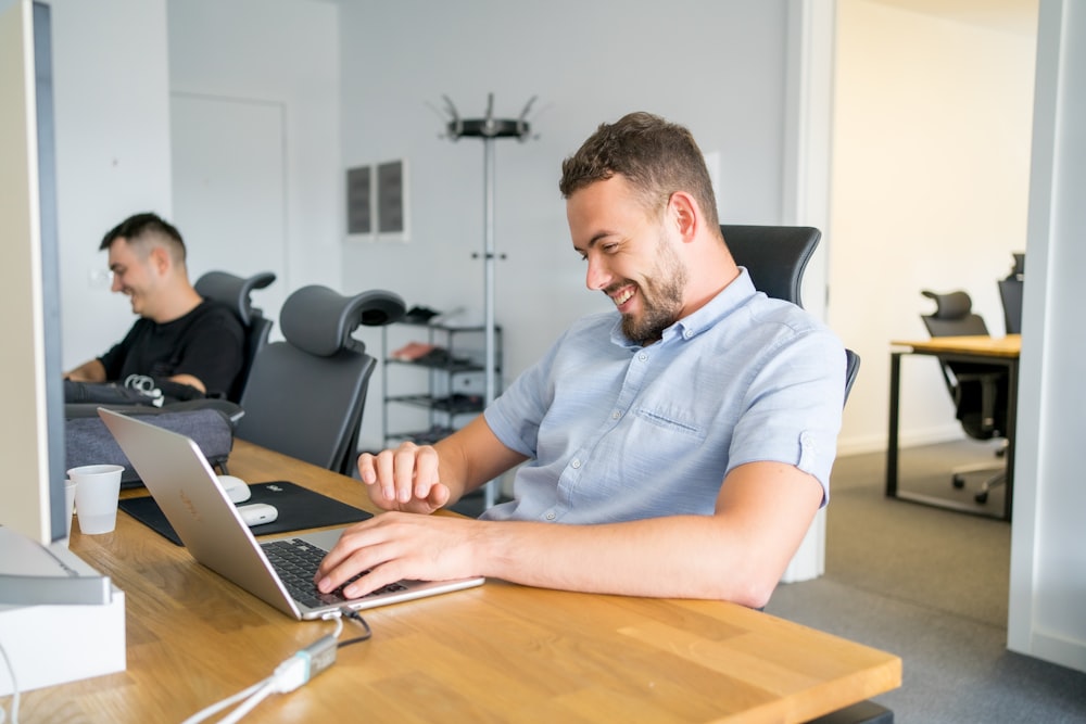 a man sitting in front of a laptop computer