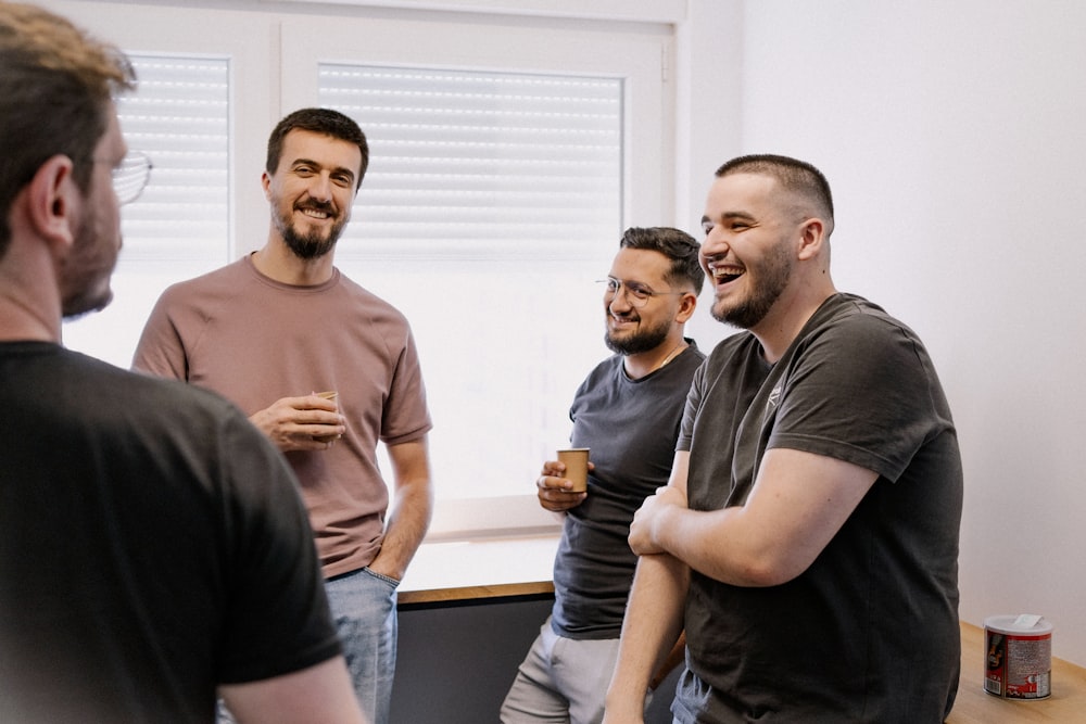 a group of men standing next to each other in a room