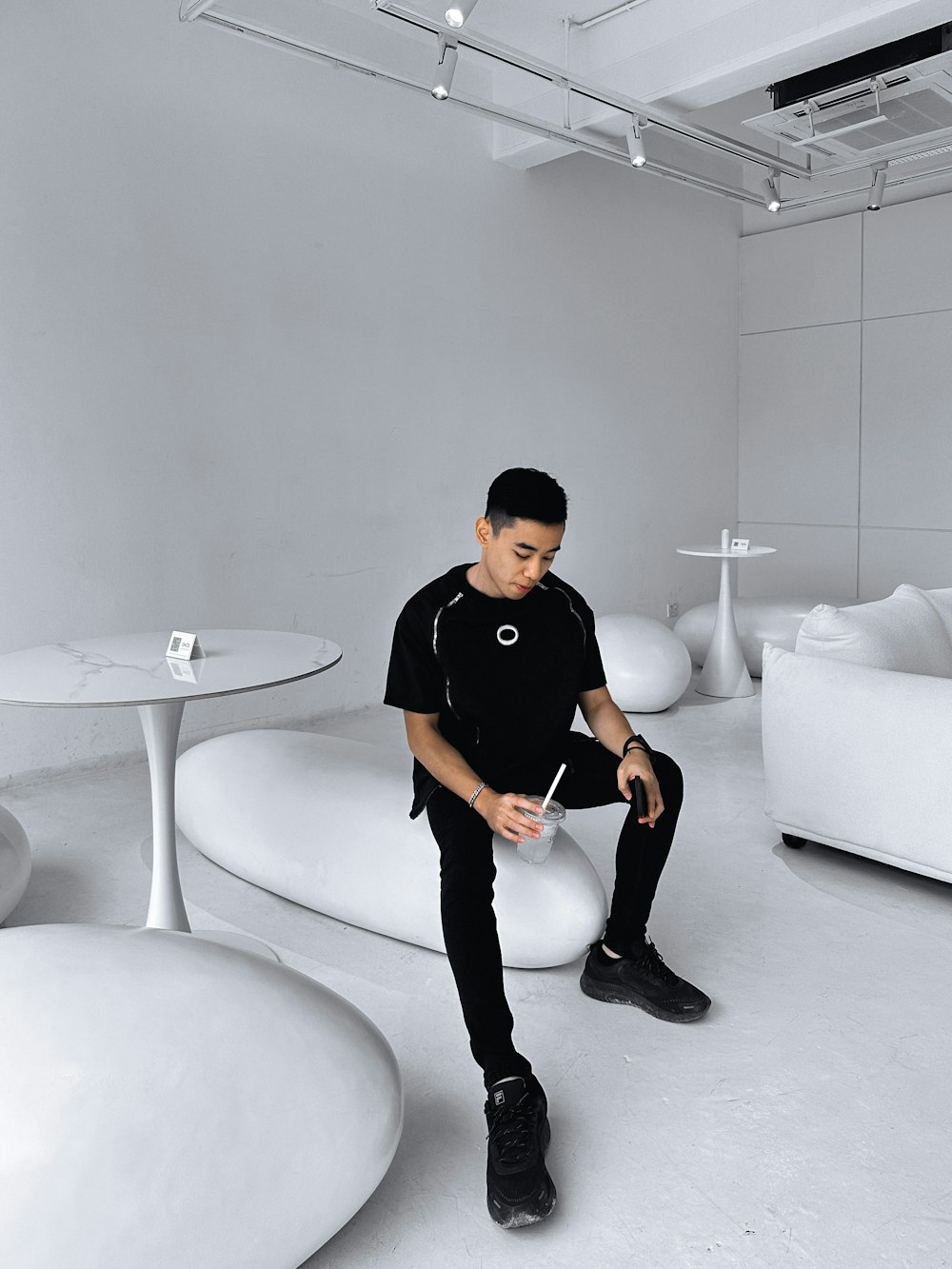 a man sitting on a white couch in a room