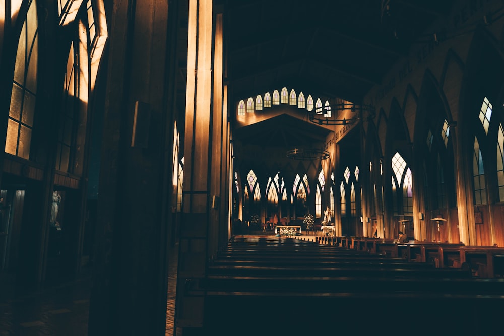 a church with stained glass windows and pews