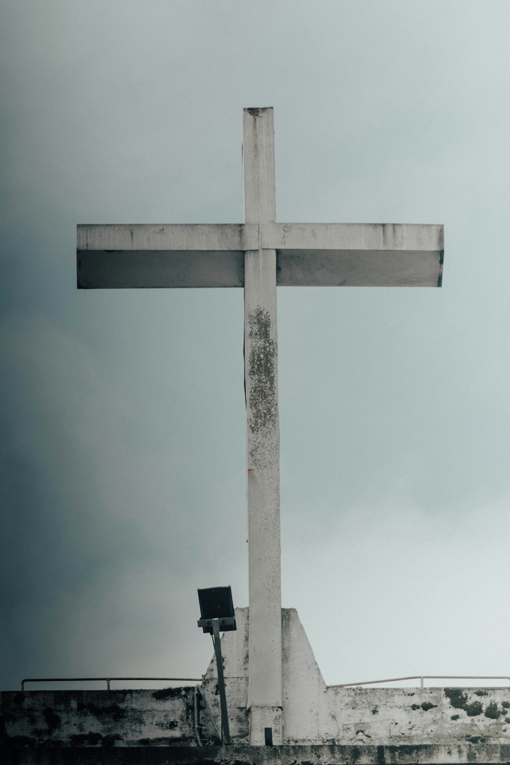 a large white cross on top of a building