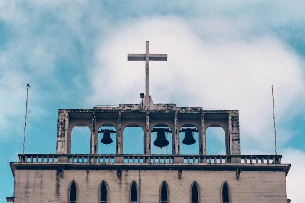 a church bell tower with a cross on top