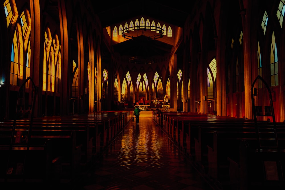 a person standing in a church with stained glass windows