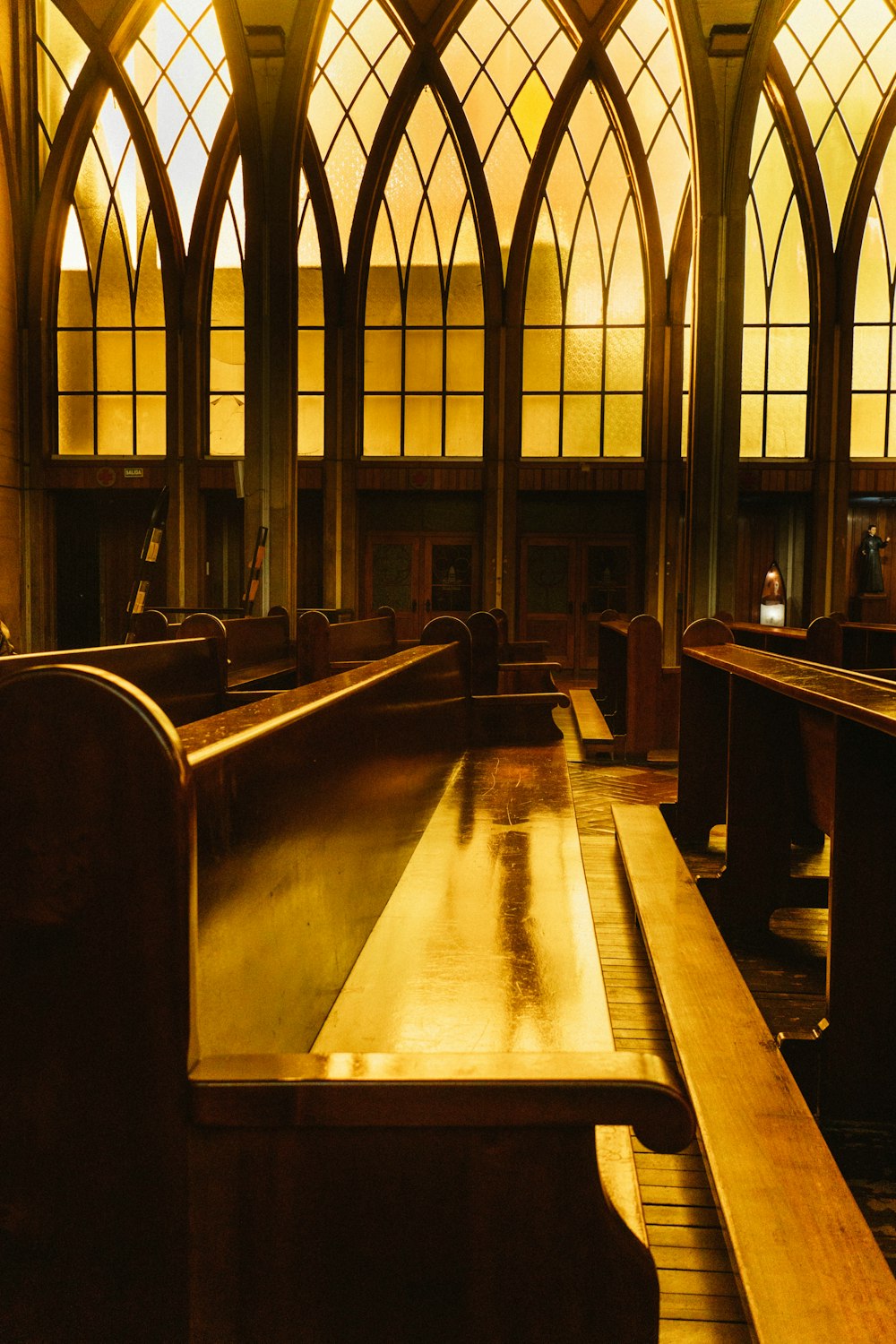 a church with stained glass windows and benches