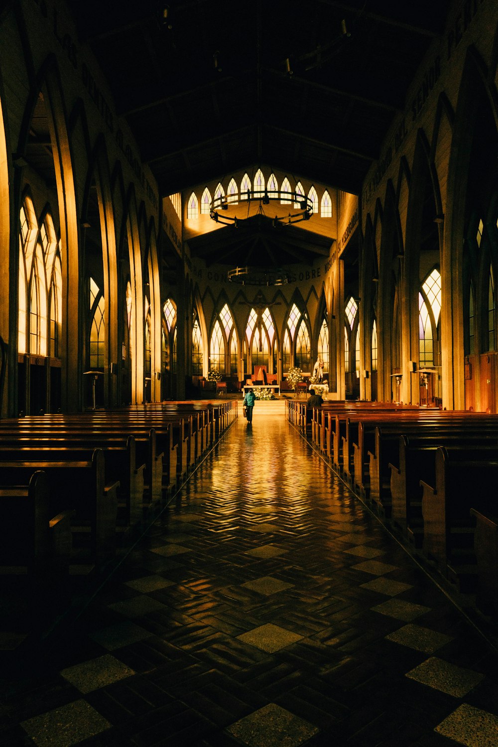a person walking down a hall in a church