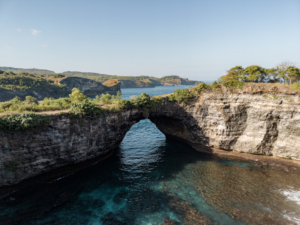 a large body of water near a rocky cliff