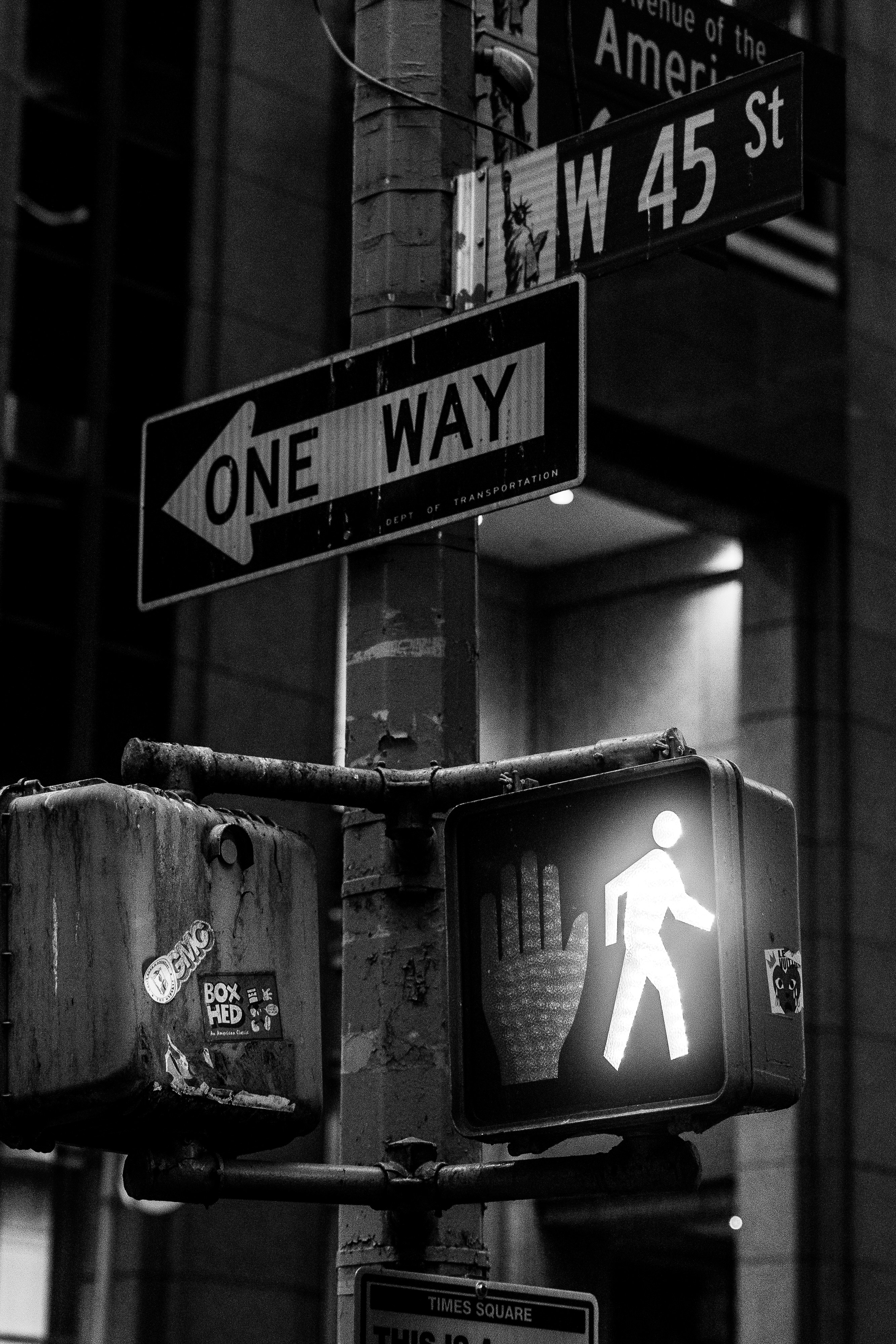 a black and white photo of a one way sign