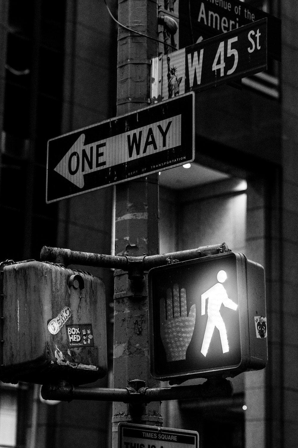 a black and white photo of a one way sign