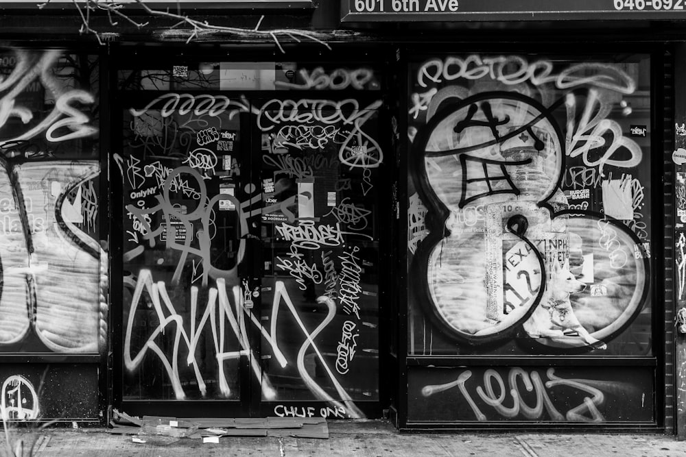 a black and white photo of graffiti on a building