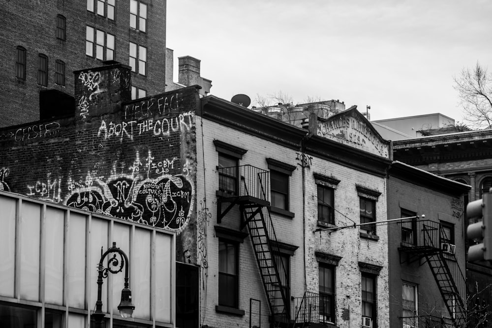 a black and white photo of a building with graffiti on it