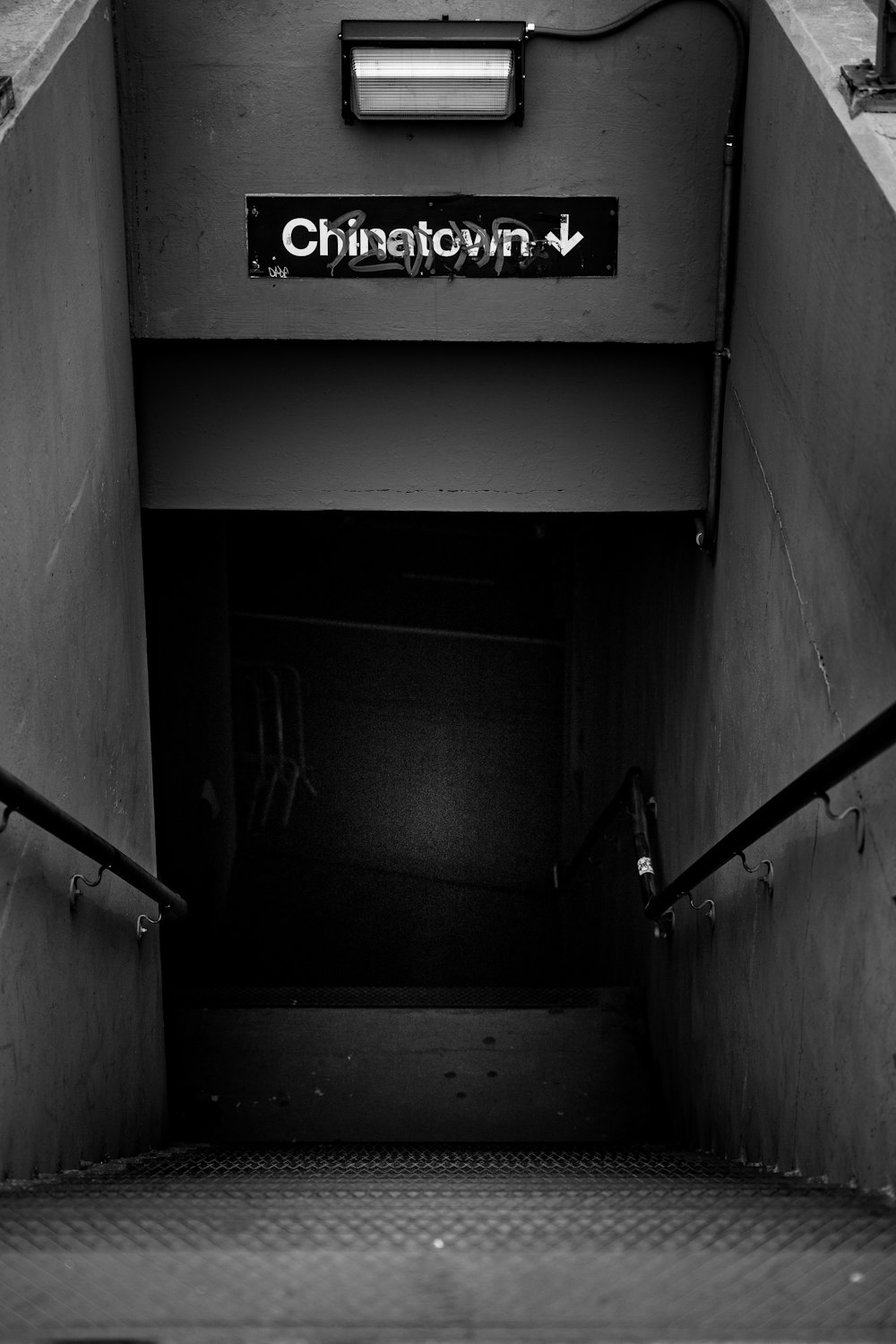 a black and white photo of a subway entrance