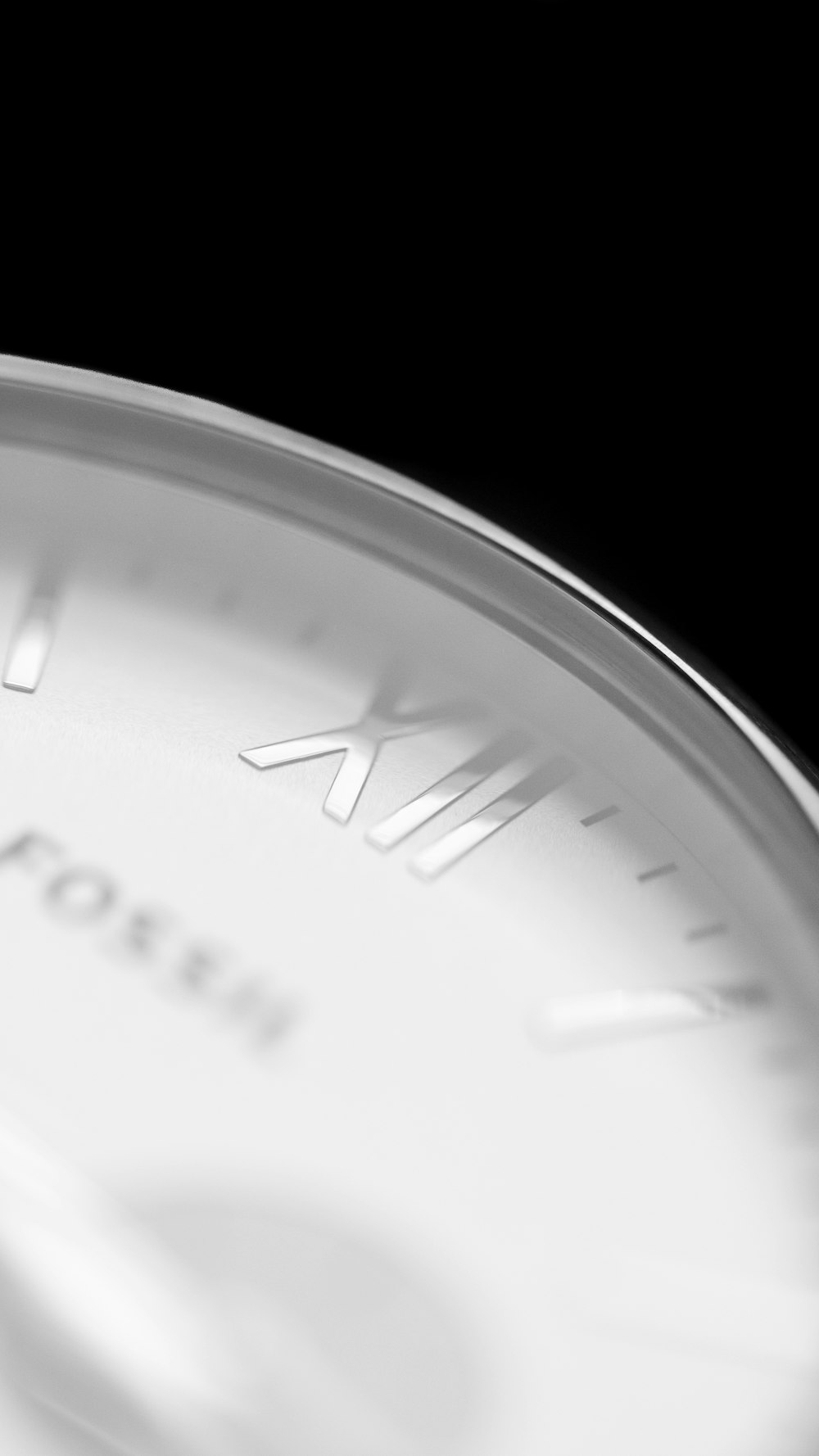 a close up of a clock face on a black background