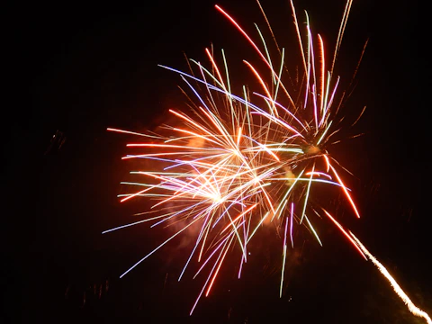 A colorful wedding fireworks show illuminating a romantic outdoor venue.