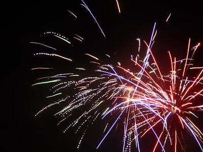 Vibrant display of colorful fireworks bursting against a dark night sky.