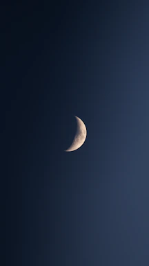 A delicate silver crescent moon cradling a cluster of twinkling stars against a deep midnight blue cosmic background.
