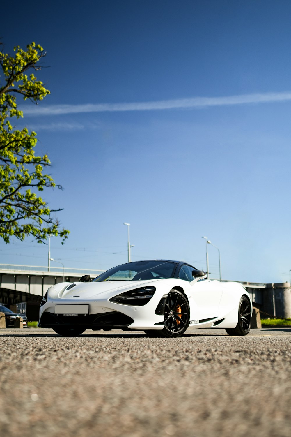 a white sports car parked in a parking lot