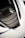 A detailed view of a car's air intake or vent area, featuring sleek carbon fiber textures and a modern design. The surface reflects light, highlighting the geometric patterns. The surrounding area is smooth, possibly indicative of a sports car body.
