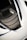 A detailed view of a car's air intake or vent area, featuring sleek carbon fiber textures and a modern design. The surface reflects light, highlighting the geometric patterns. The surrounding area is smooth, possibly indicative of a sports car body.
