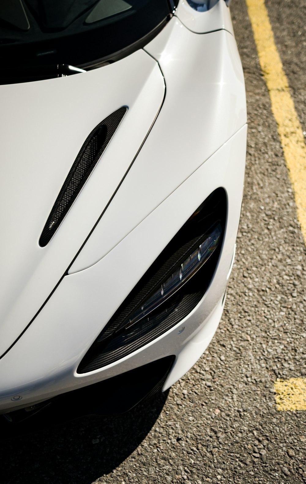 a white sports car parked in a parking lot