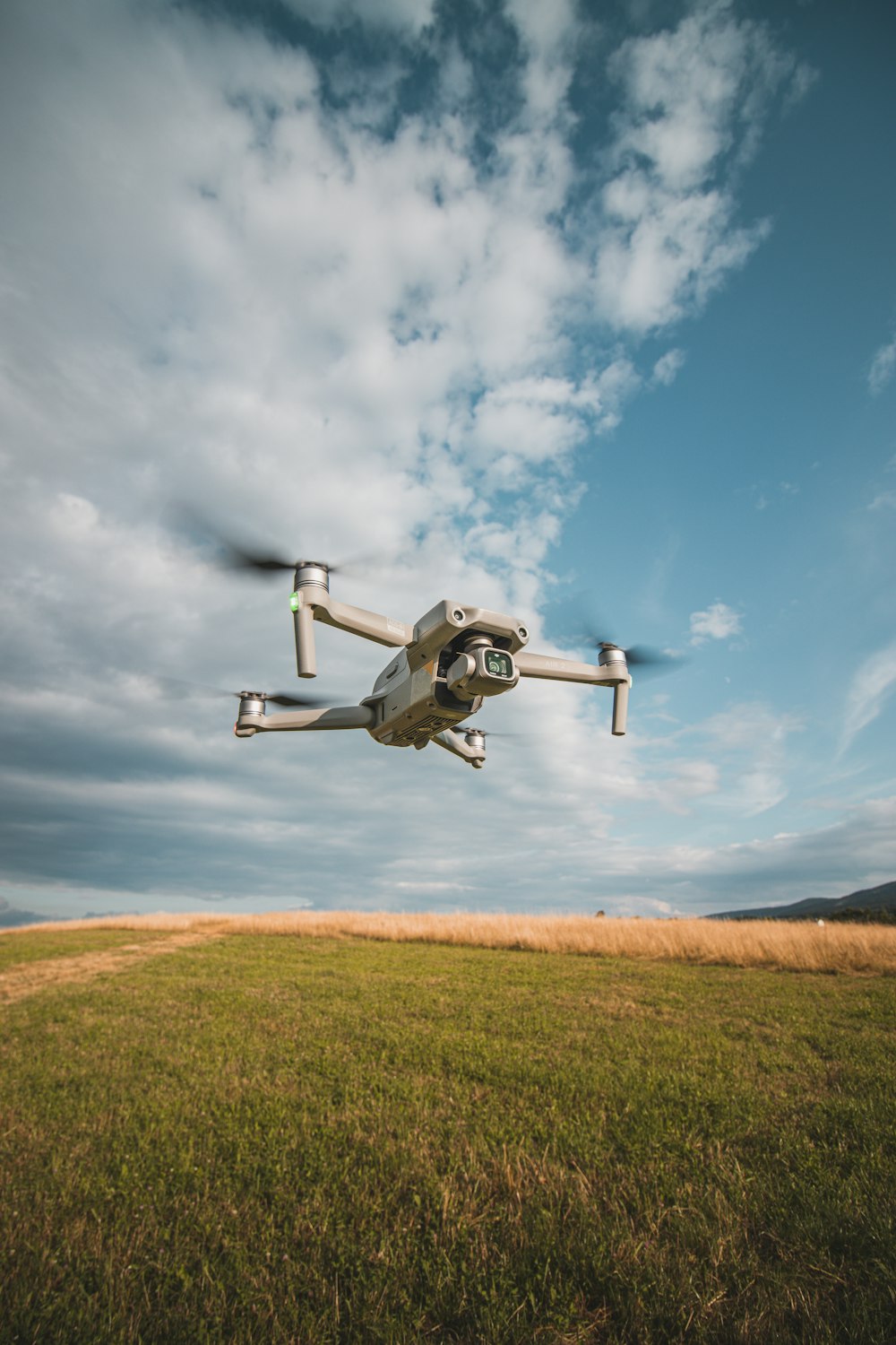 a white and black remote controlled flying over a field
