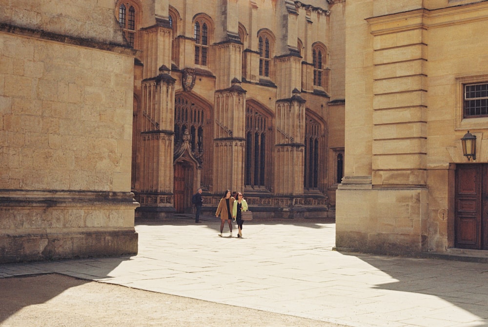 a couple of people that are standing in front of a building