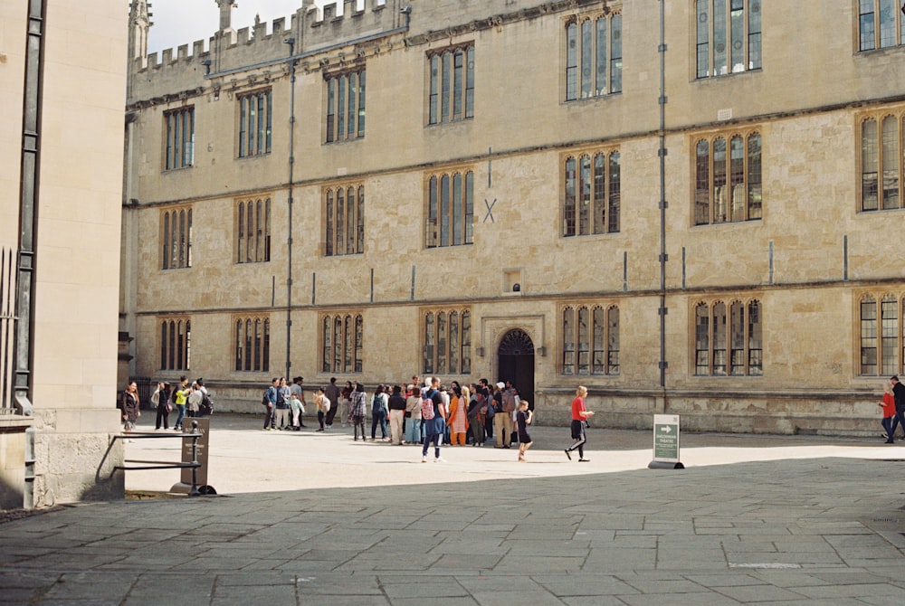 a group of people walking in front of a building