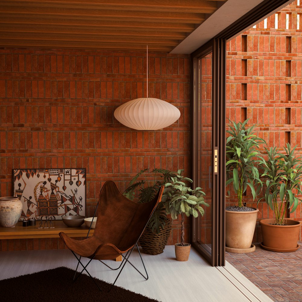 a room with a chair, potted plants and a lamp