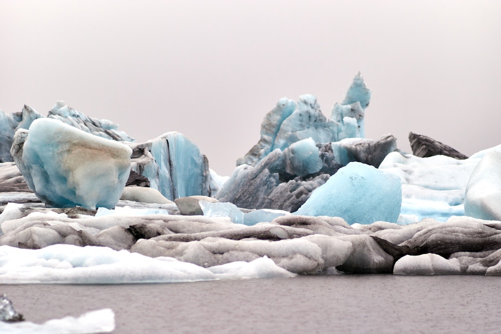 a group of icebergs floating on top of a body of water