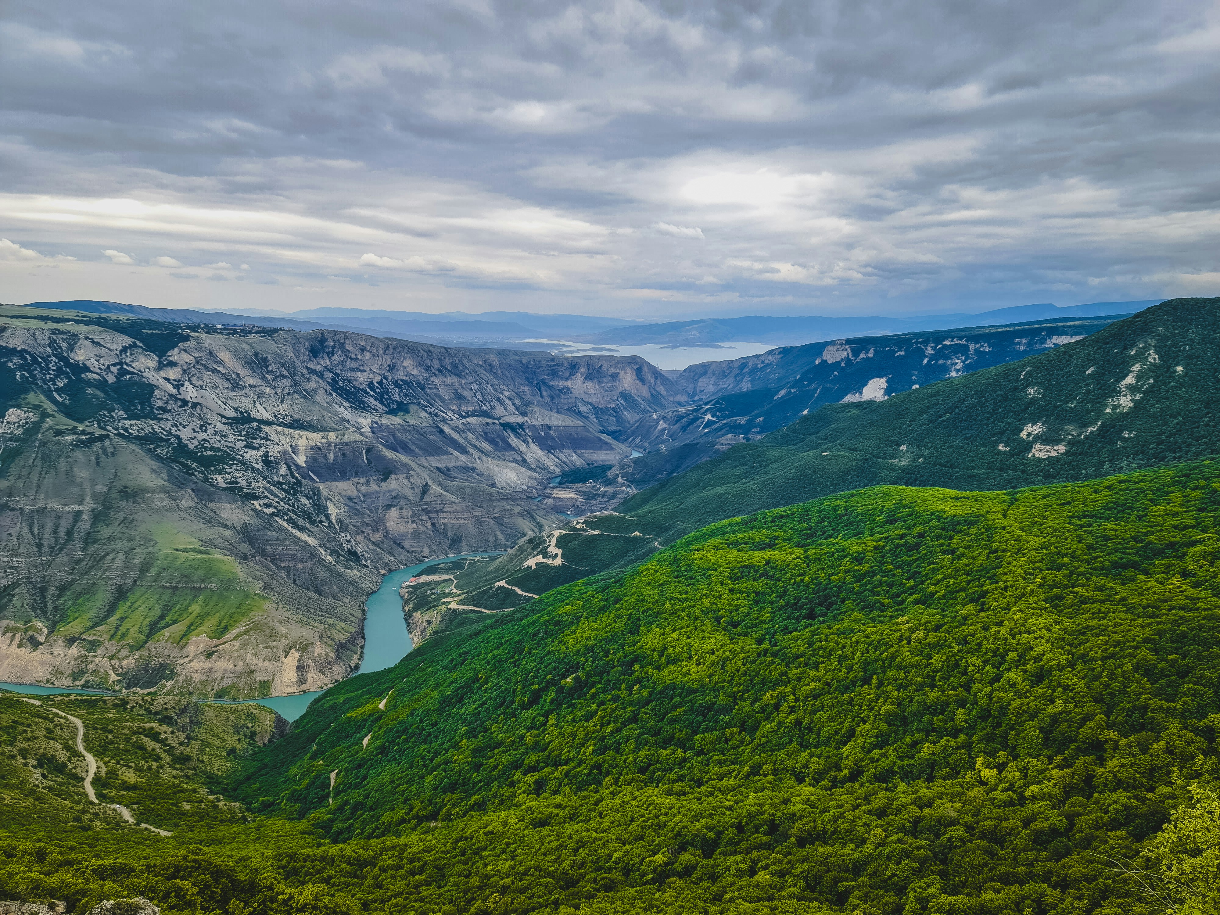 a scenic view of a valley with a river running through it