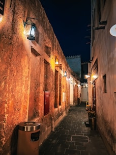 A mysterious alleyway illuminated by warm street lamps, inviting exploration.