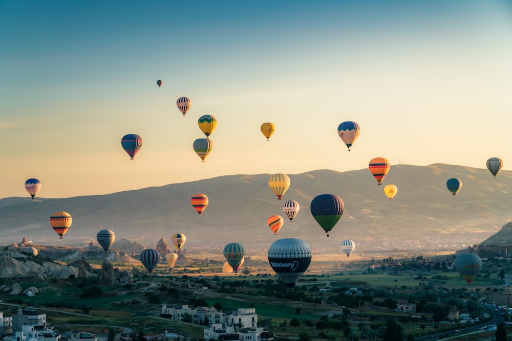 a bunch of hot air balloons flying in the sky