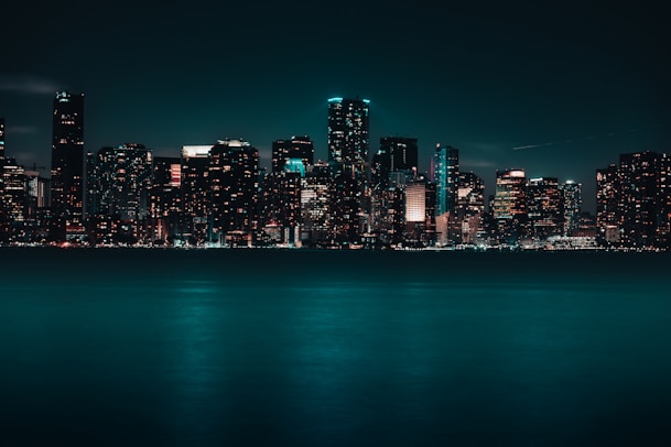 a city skyline is lit up at night