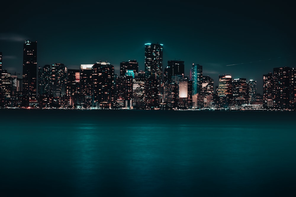 a city skyline is lit up at night