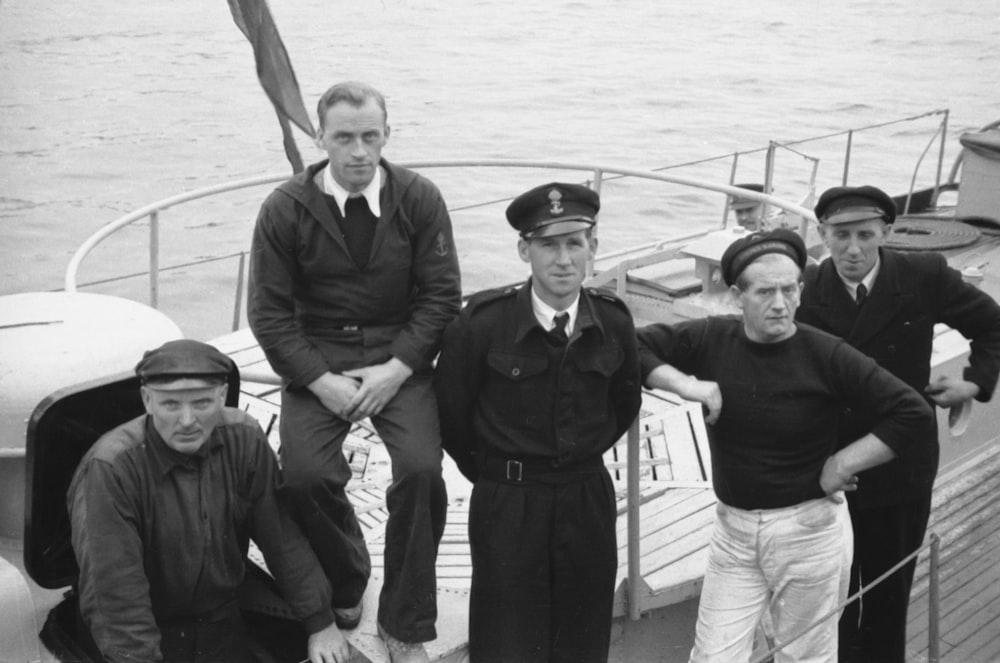 a group of men standing on top of a boat