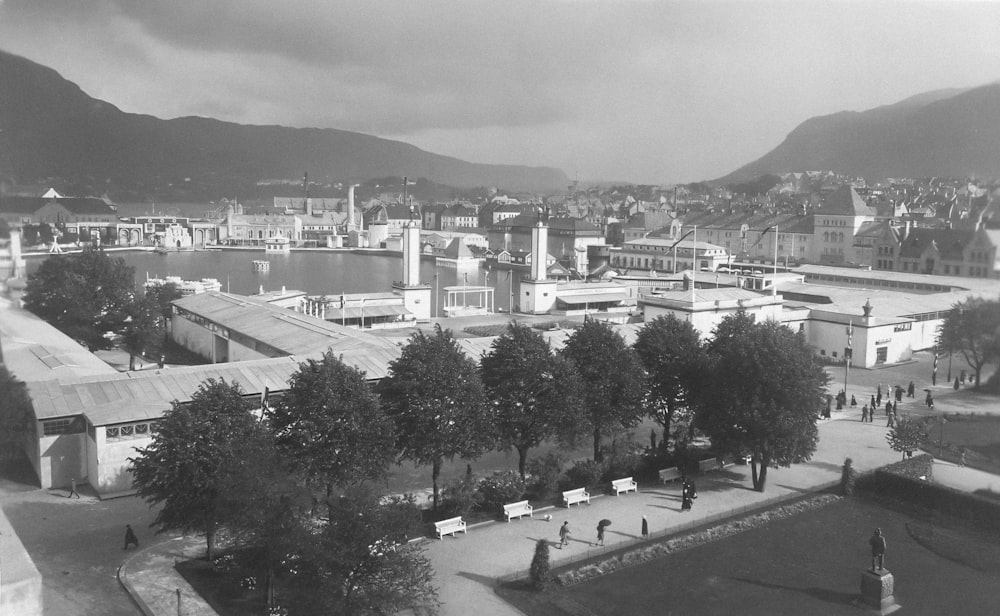 a black and white photo of a city with mountains in the background