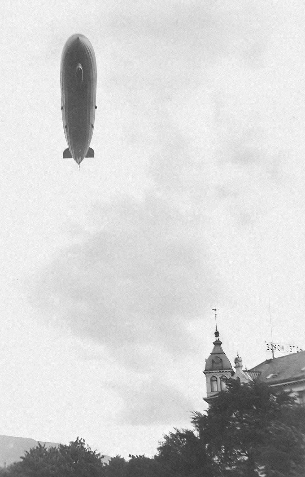 a black and white photo of an airplane in the sky