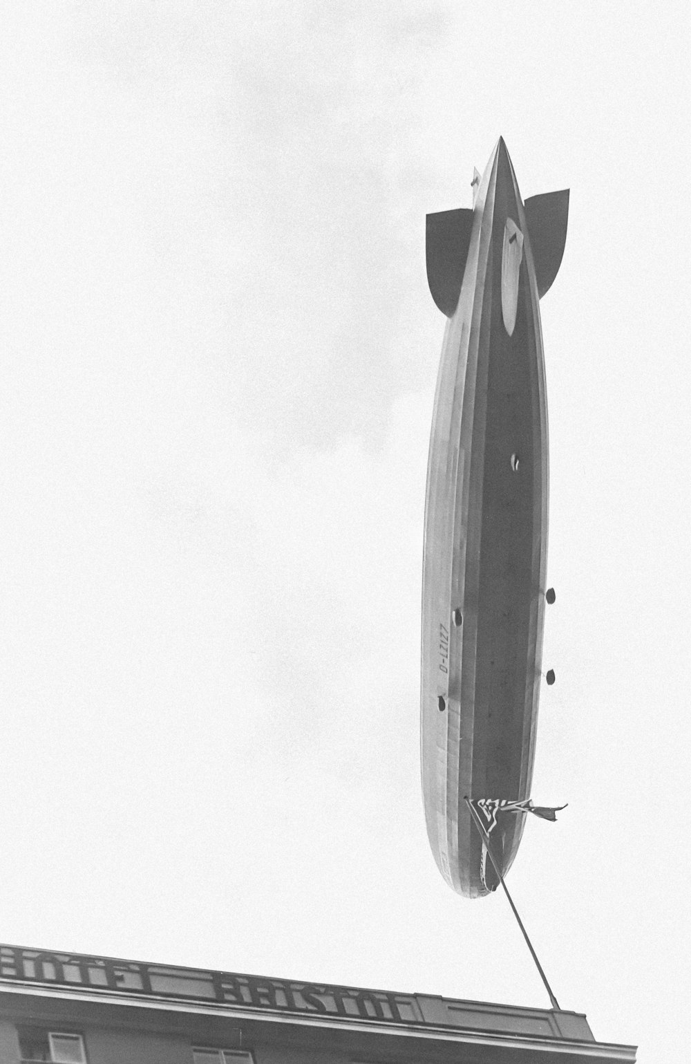 a large airplane flying over a tall building