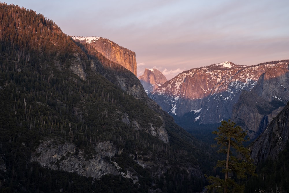 a mountain range with snow covered mountains in the background