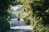 A serene outdoor scene showing a person riding a bicycle on a sunny day with blue sky.