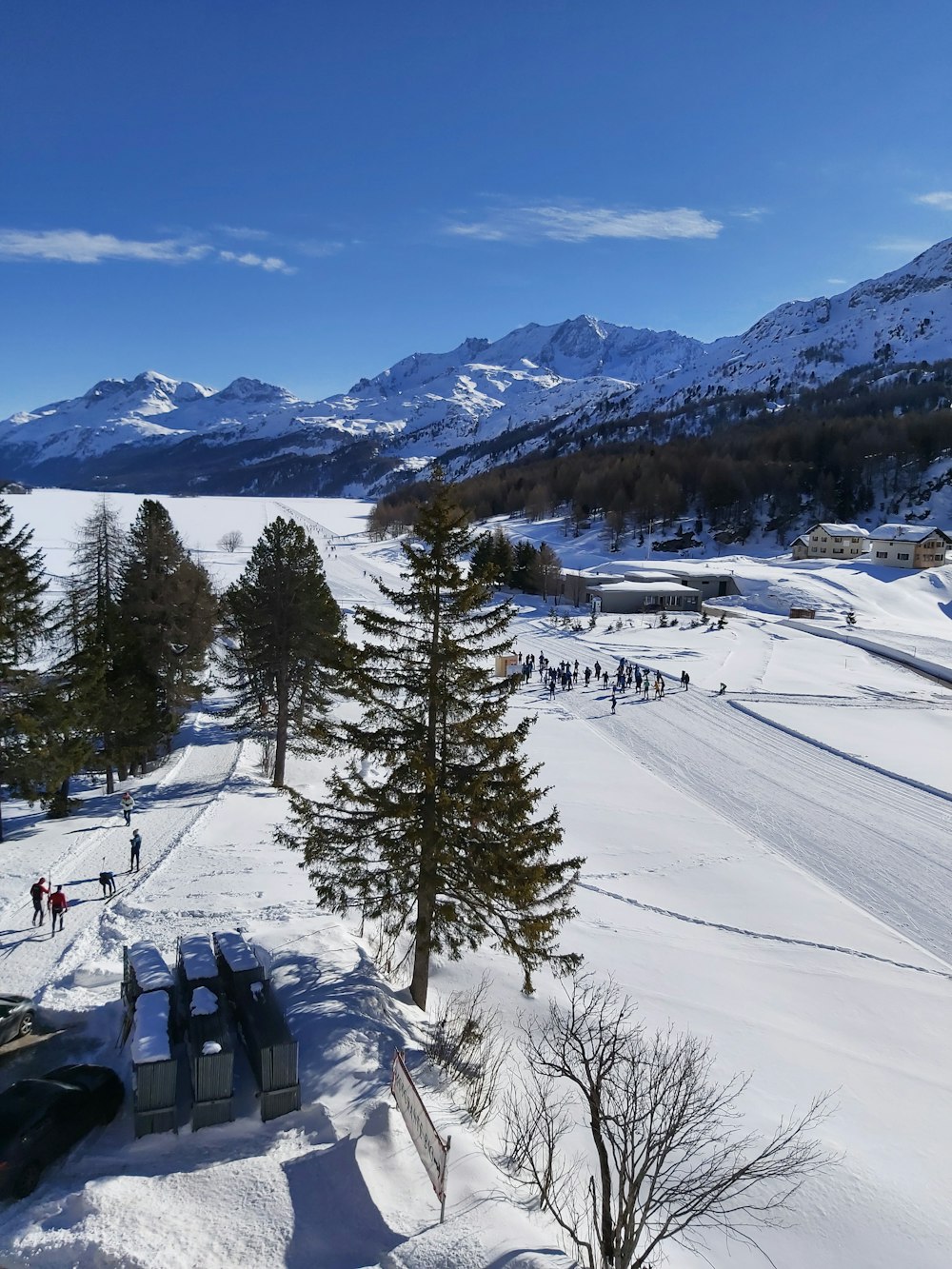 a group of people standing on top of a snow covered slope