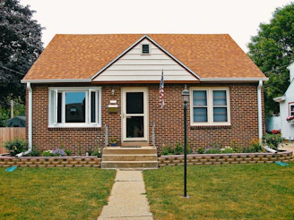 A modest, well-kept Barre home with a small garden in front.