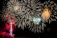 A vibrant daytime fireworks display lighting up a clear blue sky over a wedding venue.