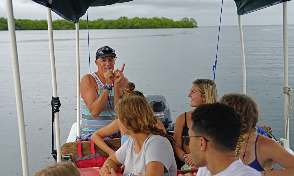 a group of people sitting on top of a boat