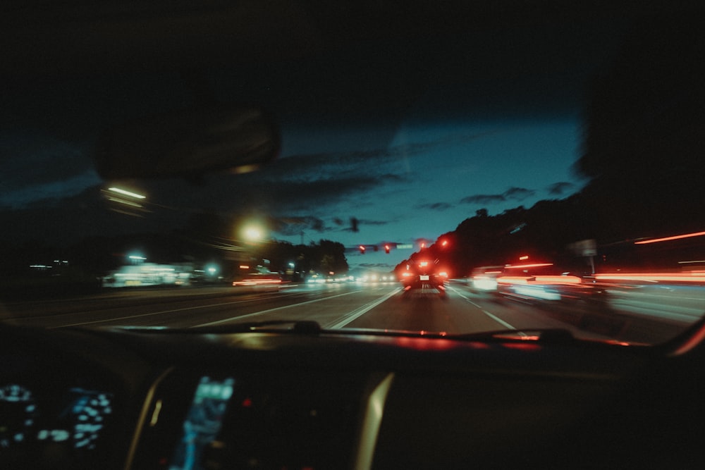 a car driving down a street at night