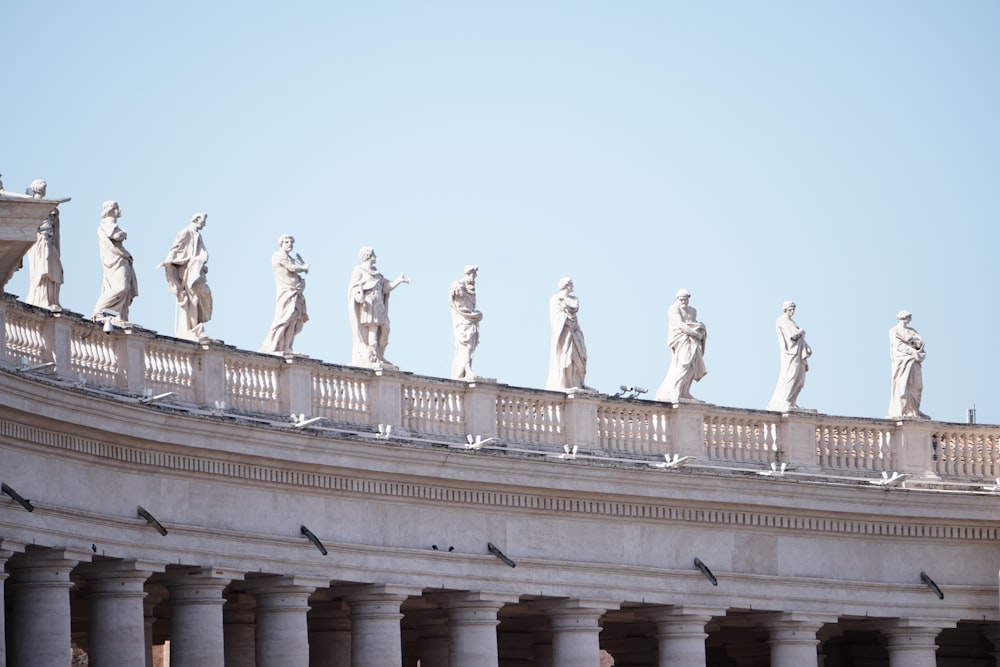 a group of statues on top of a building