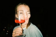 A playful scene featuring friends enjoying wine with humorous meme labels visible.