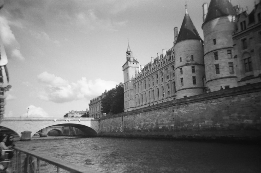 a black and white photo of a bridge and a castle