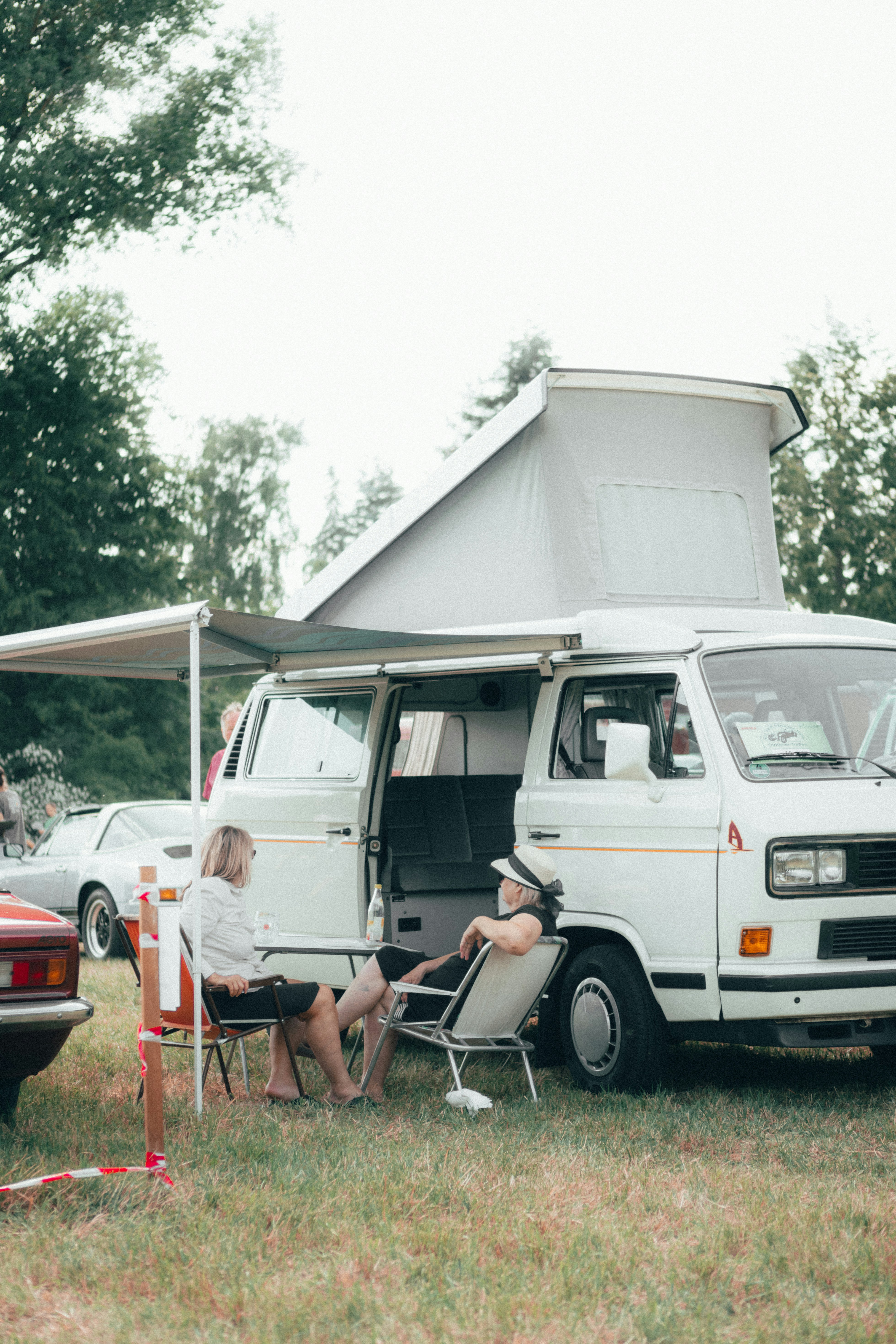 a woman sitting in a chair in front of a van